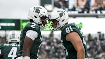 Oct 11, 2025; East Lansing, Michigan, USA; Michigan State quarterback Aidan Chiles (2) celebrates a touchdown with Michigan State tight end Michael Masunas (81) in the first quarter at Spartan Stadium. Mandatory Credit: Brendan Mullin-Imagn Images
