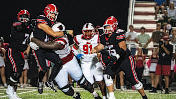 Brandon quarterback Sladen Shack (10) passes the ball while being tacked by Petal defensive lineman Corey Wells (74) during a high school football game between Petal and Brandon at Bulldog Stadium in Brandon, Miss., on Friday, Oct. 17, 2025. Petal defeated Brandon 27-21.