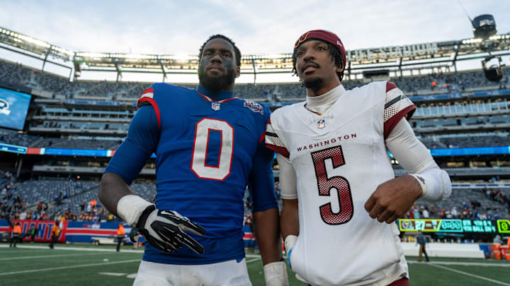 New York Giants linebacker Brian Burns (0) poses with Washington Commanders quarterback Jayden Daniels (5) after the game between the New York Giants and the Washington Commanders at MetLife Stadium in East Rutherford on Sunday, Nov. 3, 2024.