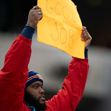A New York Giants fan holds up a sign saying, “Good job,” during a game between the Giants and the Indianapolis Colts at MetLife Stadium on Sunday, Dec. 29, 2024.