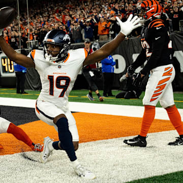 Broncos wide receiver Marvin Mims Jr. (19) reacts to scoring a touchdown as Bengals cornerback Mike Hilton (21) and safety Geno Stone (22) look on with eight seconds left in the fourth quarter at Paycor Stadium on Saturday, Dec. 28, 2024.