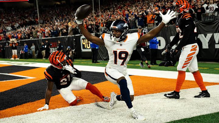 Broncos wide receiver Marvin Mims Jr. (19) reacts to scoring a touchdown as Bengals cornerback Mike Hilton (21) and safety Geno Stone (22) look on with eight seconds left in the fourth quarter at Paycor Stadium on Saturday, Dec. 28, 2024. Broncos wide receiver Marvin Mims Jr. (19) reacts to scoring a touchdown as Bengals cornerback Mike Hilton (21) and safety Geno Stone (22) look on with eight seconds left in the fourth quarter at Paycor Stadium on Saturday, Dec. 28, 2024.
