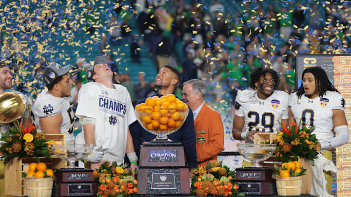 Jan 9, 2025; Miami, FL, USA; Notre Dame Fighting Irish head coach Micah Shrewsberry and quarterback Riley Leonard (13) celebrates defeating the Penn State Nittany Lions  in the Orange Bowl at Hard Rock Stadium. 