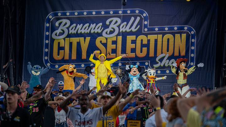 Banana Ball owner Jesse Cole dances with Mickey Mouse and friends during the Banana Ball City Selection Show on Thursday, October 15, 2026 at Historic Grayson Stadium.
