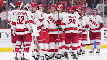 Jan 2, 2025; Sunrise, Florida, USA; Carolina Hurricanes goaltender Pyotr Kochetkov (52) is congrulted by teammtes after defeating the Florida Panthers at Amerant Bank Arena. Mandatory Credit: Rich Storry-Imagn Images