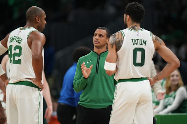 Boston Celtics head coach Joe Mazzulla talks with forward Jayson Tatum (0) and center Al Horford (42) from the sideline.