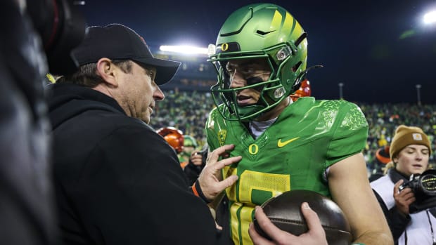 Nov 24, 2023; Eugene, Oregon, USA; Oregon Ducks quarterback Bo Nix (10) is congratulated by Oregon State Beavers head coach J