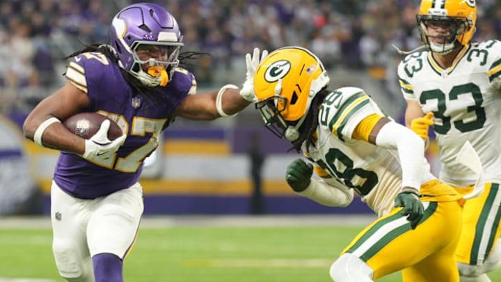 Jan 4, 2026; Minneapolis, Minnesota, USA; Minnesota Vikings running back Jordan Mason (27) runs the ball against Green Bay Packers cornerback Trevon Diggs (28) during the second quarter at U.S. Bank Stadium.