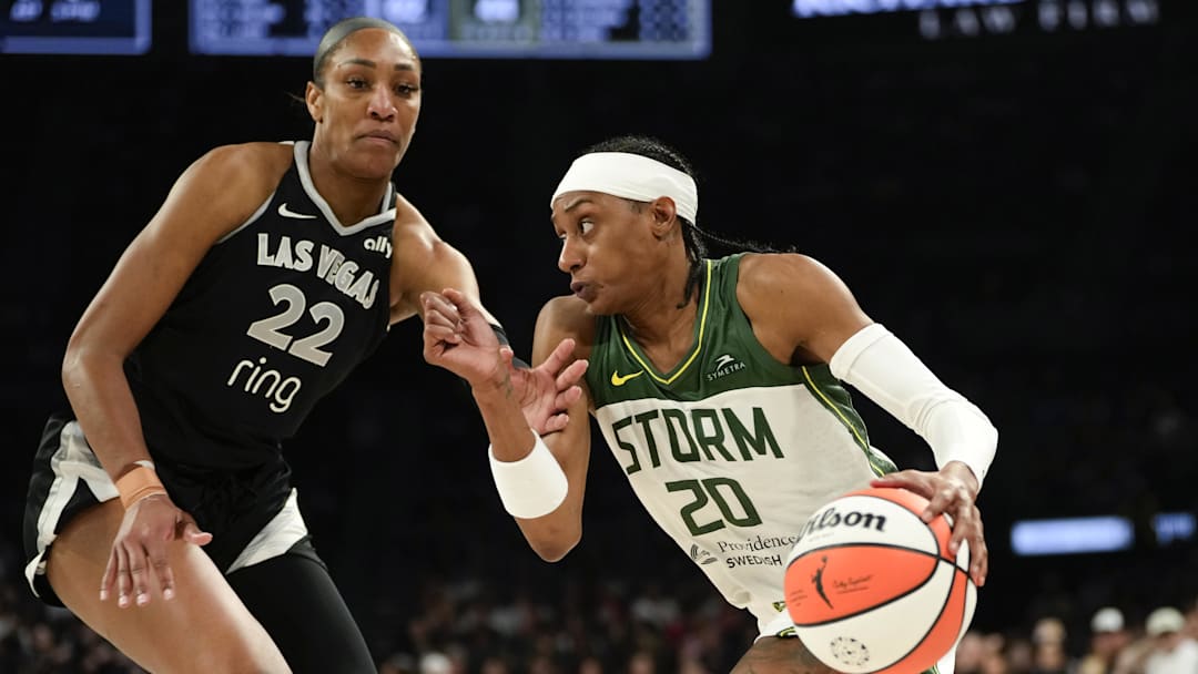 Aug 8, 2025; Las Vegas, Nevada, USA; Seattle Storm guard Brittney Sykes (20) drives the ball against Las Vegas Aces center A'ja Wilson (22) during the second half of a WNBA basketball game at Michelob Ultra Arena. Mandatory Credit: Lucas Peltier-Imagn Images