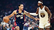 Dec 6, 2025; Cleveland, Ohio, USA; Cleveland Cavaliers guard Jaylon Tyson (20) brings the ball up court against Golden State Warriors guard Buddy Hield (7) during the first half at Rocket Arena. Mandatory Credit: Ken Blaze-Imagn Images