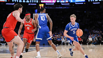 Dec 21, 2024; New York, New York, USA; Kentucky Wildcats guard Collin Chandler (5) sets the play while being defended by Ohio State Buckeyes guard Micah Parrish (8) and center Austin Parks (25) during the first half at Madison Square Garden. Mandatory Credit: John Jones-Imagn Images