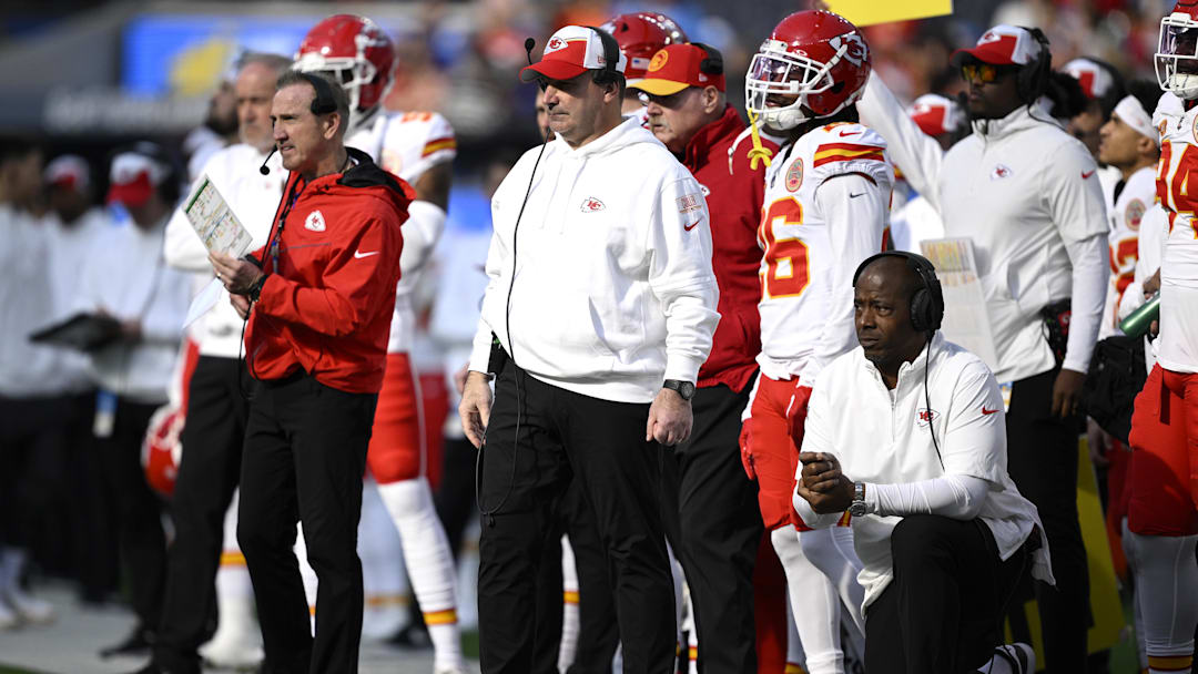 Jan 7, 2024; Inglewood, California, USA; Kansas City Chiefs defensive line coach Joe Cullen (center) looks on from the sideline alongside defensive coordinator Steve Spagnuolo (left) and defensive backs coach Dave Merritt (bottom, right) during the first half against the Los Angeles Chargers at SoFi Stadium. Mandatory Credit: Orlando Ramirez-Imagn Images