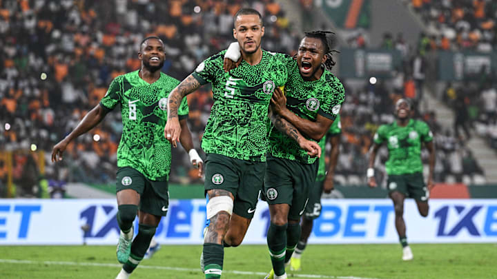 Nigeria players rush to celebrate with William Troost-Ekong after his minute 67 penalty put the Super Eagles up 1-0 on South Africa in an African Cup of Nations semifinal match.