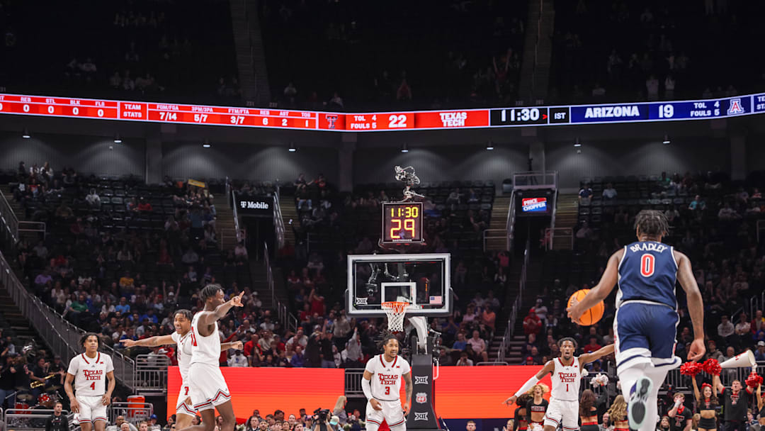 Mar 14, 2025; Kansas City, MO, USA; Arizona Wildcats guard Jaden Bradley (0) brings the ball up court during the first half against the Texas Tech Red Raiders at T-Mobile Center. Mandatory Credit: William Purnell-Imagn Images
