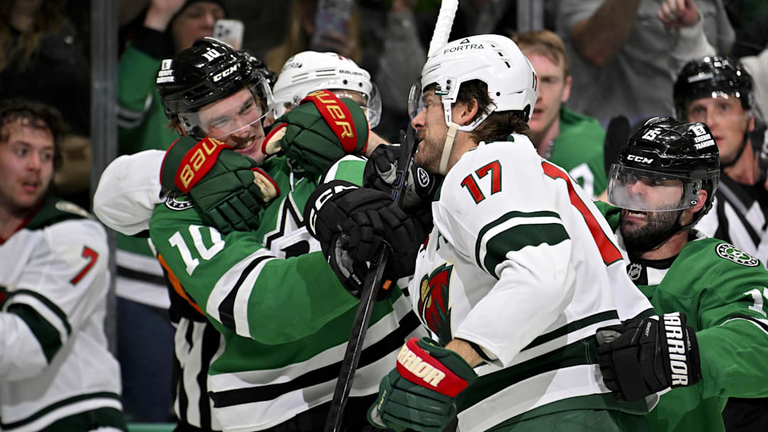 Apr 9, 2026; Dallas, Texas, USA; Dallas Stars center Oskar Back (10) fights with Minnesota Wild left wing Marcus Foligno (17) during the second period at the American Airlines Center. Mandatory Credit: Jerome Miron-Imagn Images