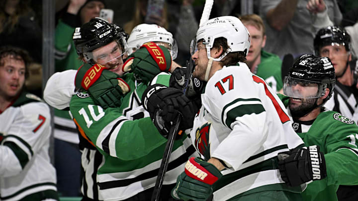 Apr 9, 2026; Dallas, Texas, USA; Dallas Stars center Oskar Back (10) fights with Minnesota Wild left wing Marcus Foligno (17) during the second period at the American Airlines Center. Mandatory Credit: Jerome Miron-Imagn Images