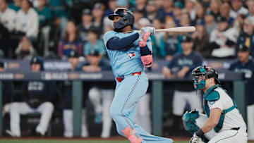 Oct 17, 2025; Seattle, Washington, USA; Toronto Blue Jays first baseman Vladimir Guerrero Jr. (27) hits a double against the Seattle Mariners in the first inning during game five of the ALCS round for the 2025 MLB playoffs at T-Mobile Park. Mandatory Credit: Stephen Brashear-Imagn Images