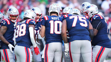 Dec 15, 2024; Glendale, Arizona, USA; New England Patriots quarterback Drake Maye (10) huddles teammates against the Arizona Cardinals during the first half at State Farm Stadium. Mandatory Credit: Joe Camporeale-Imagn Images