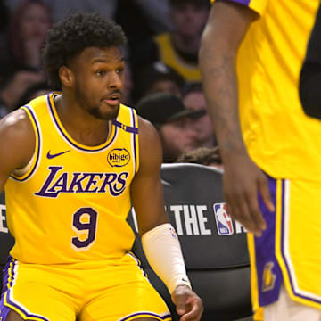 Mar 19, 2025; Los Angeles, California, USA;  Los Angeles Lakers guard Bronny James (9) sits on the bench during a time out in the second half against the Denver Nuggets at Crypto.com Arena. Mandatory Credit: Jayne Kamin-Oncea-Imagn Images