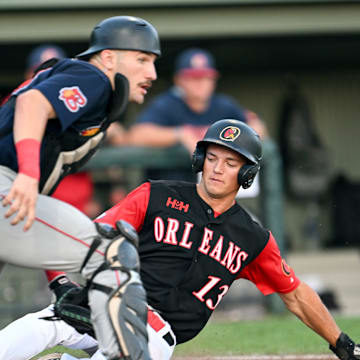 ORLEANS  8/11/23  Fenwick Trimble of Orleans slides across the plate ahead of the throw to Bourne catcher Derek Bender.  Cape League finals