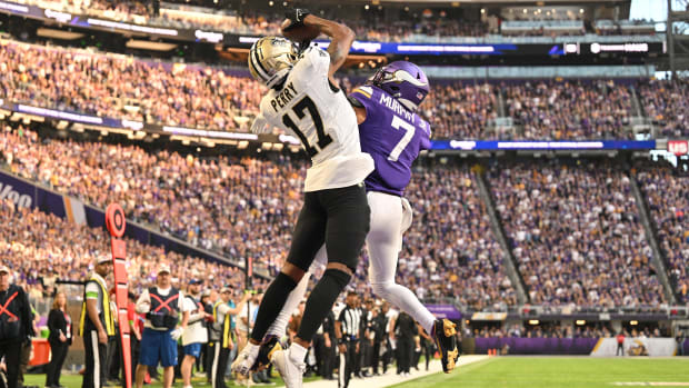 New Orleans Saints wide receiver A.T. Perry (17) catches a touchdown pass over Minnesota Vikings cornerback Byron Murphy Jr. 