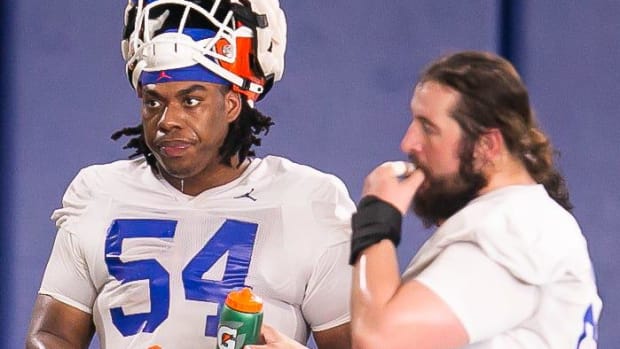 Florida Gators offensive lineman Micah Mazzccua (54) grabs some water between drills Tuesday.