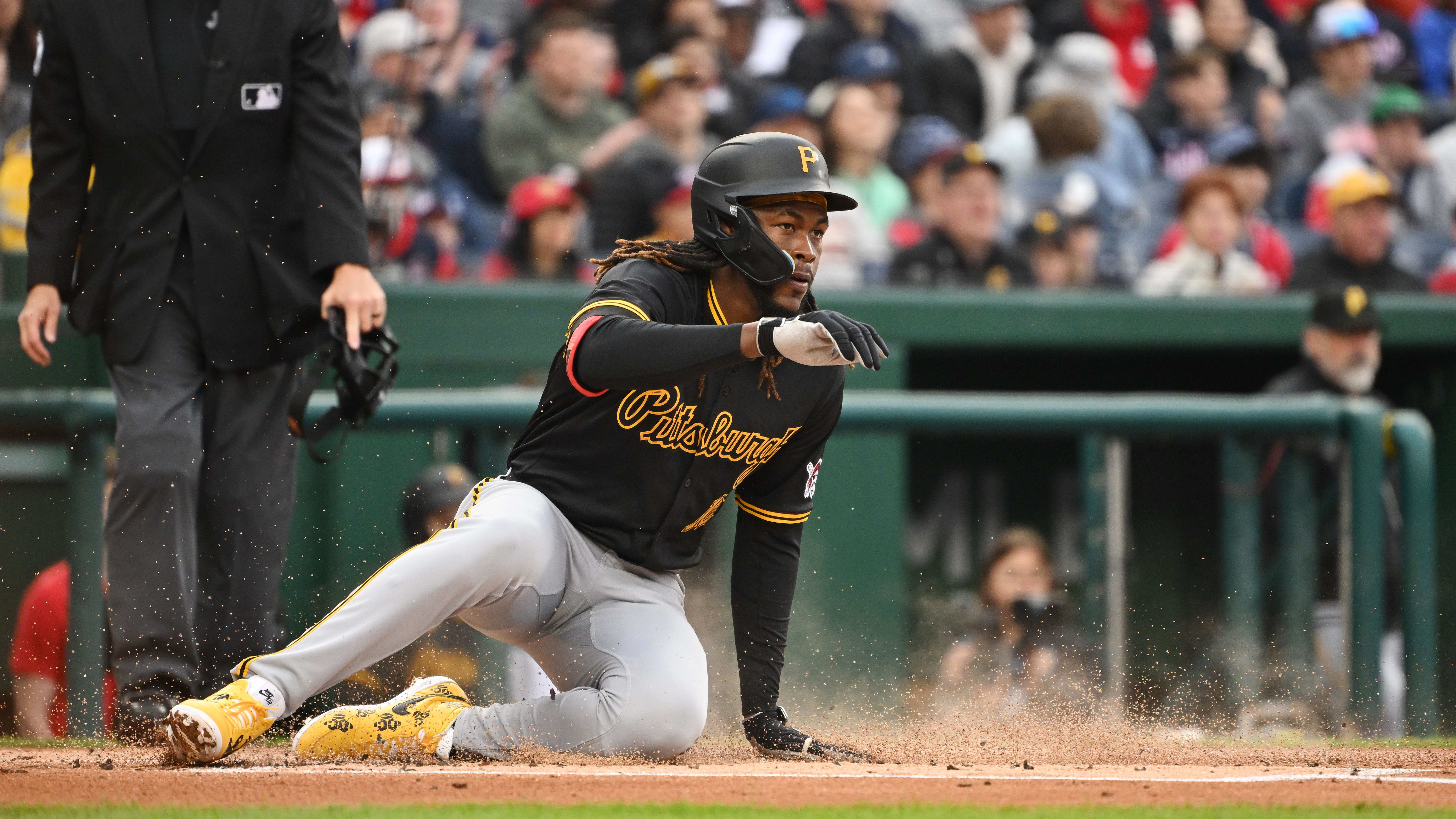 Apr 1, 2024; Washington, District of Columbia, USA; Pittsburgh Pirates shortstop Oneil Cruz (15) slides into home plate.