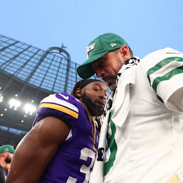 Oct 6, 2024; Tottenham, ENG; New York Jets quarterback Aaron Rodgers (8) speaks with Minnesota Vikings Running Back Aaron Jones (33) after the 17-23 defeat at Tottenham Hotspur Stadium. Mandatory Credit: Shaun Brooks-Imagn Images