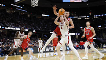 Mar 23, 2025; Cleveland, OH, USA; Alabama Crimson Tide forward Grant Nelson (4) looks to the basket defended by St. Mary's Gaels center Mitchell Saxen (11) in the second half during the NCAA Tournament Second Round at Rocket Arena. Mandatory Credit: Rick Osentoski-Imagn Images