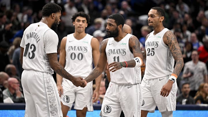 Feb 21, 2025; Dallas, Texas, USA; Dallas Mavericks guard Kyrie Irving (11) and forward Naji Marshall (13) and guard Max Christie (00) and forward P.J. Washington (25) celebrate after Irving makes a three point shot against the New Orleans Pelicans during the second half at the American Airlines Center. Mandatory Credit: Jerome Miron-Imagn Images