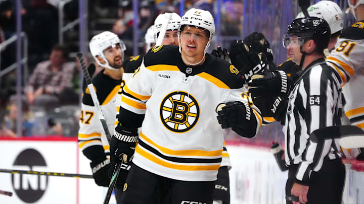 Oct 16, 2024; Denver, Colorado, USA; Boston Bruins defenseman Hampus Lindholm (27) celebrates his goal with teammates in the second period against the Colorado Avalanche at Ball Arena. Mandatory Credit: Ron Chenoy-Imagn Images