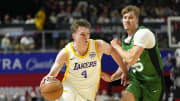 Jul 15, 2024; Las Vegas, NV, USA; Los Angeles Lakers forward Dalton Knecht (4) drives the ball against Boston Celtics guard Baylor Scheierman (55) during the first half at Thomas & Mack Center. Mandatory Credit: Lucas Peltier-USA TODAY Sports