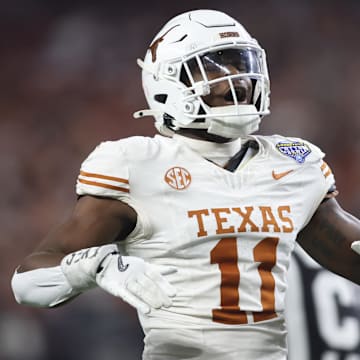Jan 10, 2025; Arlington, Texas, USA; Texas Longhorns linebacker Colin Simmons (11) celebrates after a pass break up during the third quarter of the College Football Playoff semifinal against the Ohio State Buckeyes in the Cotton Bowl at AT&T Stadium. Mandatory Credit: Tim Heitman-Imagn Images