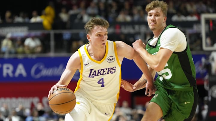 Jul 15, 2024; Las Vegas, NV, USA; Los Angeles Lakers forward Dalton Knecht (4) drives the ball against Boston Celtics guard Baylor Scheierman (55) during the first half at Thomas & Mack Center. Mandatory Credit: Lucas Peltier-Imagn Images