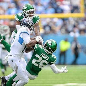 Sep 15, 2024; Nashville, Tennessee, USA;  New York Jets defensive back Brandin Echols (20) intercepts the pass thrown to Tennessee Titans wide receiver Treylon Burks (16) during the first half at Nissan Stadium. 