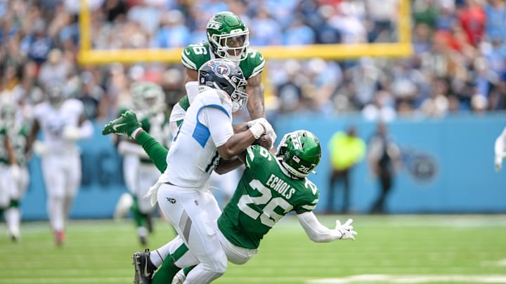 Sep 15, 2024; Nashville, Tennessee, USA;  New York Jets defensive back Brandin Echols (20) intercepts the pass thrown to Tennessee Titans wide receiver Treylon Burks (16) during the first half at Nissan Stadium. 