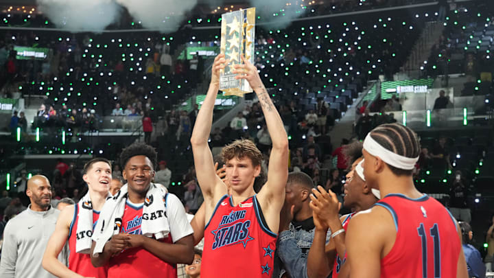 Feb 13, 2026; Inglewood, California, USA; Team Vince frontcourt Matas Buzelis (14) of the Chicago Bulls celebrates with the trophy after defeating Team Melo during an NBA All Star Rising Stars championship game at Intuit Dome. Mandatory Credit: Kirby Lee-Imagn Images