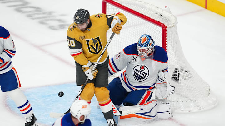 May 6, 2025; Las Vegas, Nevada, USA; Vegas Golden Knights center Nicolas Roy (10) attempts to deflect the puck towards Edmonton Oilers goaltender Calvin Pickard (30) during the third period of  game one of the second round of the 2025 Stanley Cup Playoffs at T-Mobile Arena. Mandatory Credit: Stephen R. Sylvanie-Imagn Images