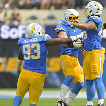 Sep 8, 2024; Inglewood, California, USA;  Los Angeles Chargers linebacker Joey Bosa (97) celebrates with defensive tackle Otito Ogbonnia (93) and linebacker Tuli Tuipulotu (45) after forcing a fumble in the second half against the Las Vegas Raiders at SoFi Stadium. Mandatory Credit: Jayne Kamin-Oncea-Imagn Images