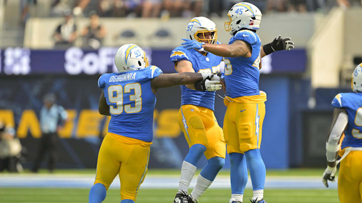 Sep 8, 2024; Inglewood, California, USA;  Los Angeles Chargers linebacker Joey Bosa (97) celebrates with defensive tackle Otito Ogbonnia (93) and linebacker Tuli Tuipulotu (45) after forcing a fumble in the second half against the Las Vegas Raiders at SoFi Stadium. Mandatory Credit: Jayne Kamin-Oncea-Imagn Images