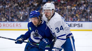 Feb 8, 2025; Vancouver, British Columbia, CAN; Vancouver Canucks forward Kiefer Sherwood (44) checks Toronto Maple Leafs forward Auston Matthews (34) in the second period at Rogers Arena. Mandatory Credit: Bob Frid-Imagn Images