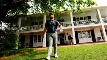 Jon Rahm leaves the clubhouse on his way to the first tee during the first round of The Masters golf