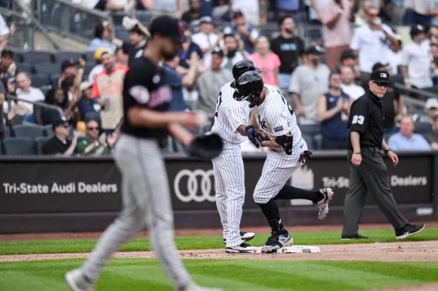 Giancarlo Stanton rounds the bases after hitting a three run home run.