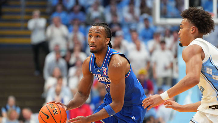 Nov 7, 2025; Chapel Hill, North Carolina, USA; Kansas Jayhawks guard Darryn Peterson (22) dribbles as North Carolina Tar Heels guard Seth Trimble (7) defends in the first half at Dean E. Smith Center. Mandatory Credit: Bob Donnan-Imagn Images