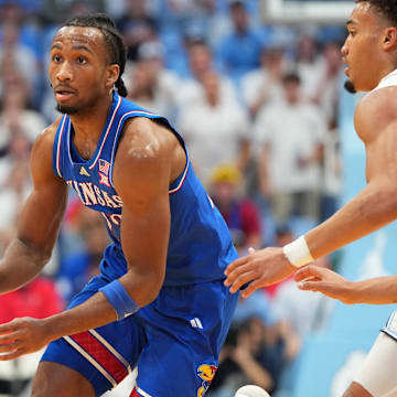 Nov 7, 2025; Chapel Hill, North Carolina, USA; Kansas Jayhawks guard Darryn Peterson (22) dribbles as North Carolina Tar Heels guard Seth Trimble (7) defends in the first half at Dean E. Smith Center. Mandatory Credit: Bob Donnan-Imagn Images