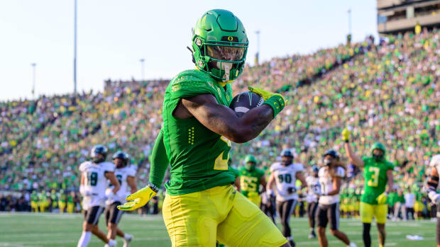 Oregon Ducks wide receiver Traeshon Holden catches a touchdown pass during a college football game.