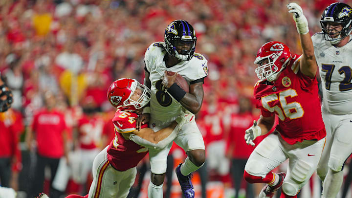 Baltimore Ravens quarterback Lamar Jackson (8) runs the ball against Kansas City Chiefs linebacker Leo Chenal (54) and defensive end George Karlaftis (56) during the second half at GEHA Field at Arrowhead Stadium. 