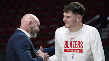 Oct 25, 2024; Portland, Oregon, USA; Portland Trail Blazers general manager Joe Cronin greets center Donovan Clingan (23) before a game against the New Orleans Pelicans at Moda Center. Mandatory Credit: Soobum Im-Imagn Images