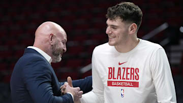 Oct 25, 2024; Portland, Oregon, USA; Portland Trail Blazers general manager Joe Cronin greets center Donovan Clingan (23) before a game against the New Orleans Pelicans at Moda Center. Mandatory Credit: Soobum Im-Imagn Images