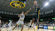 Jan 24, 2024; Wichita, Kansas, USA; East Carolina Pirates forward Brandon Johnson (6) puts up a shot over Wichita State Shockers guard Harlond Beverly (20) during the second half at Charles Koch Arena. Mandatory Credit: William Purnell-Imagn Images